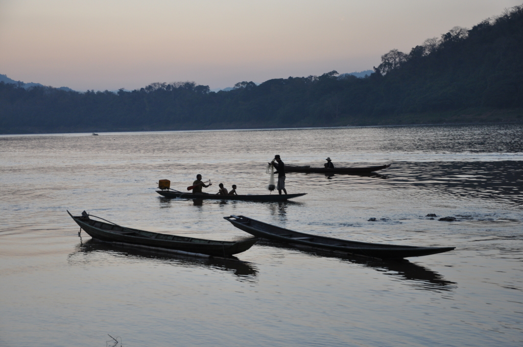 a group of people in canoes on a lake