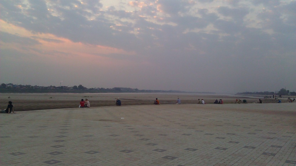 a group of people sitting on a brick path
