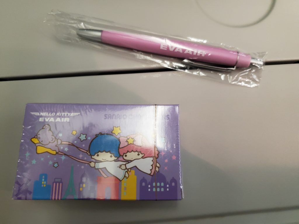 My flight souvenirs: a Hello Kitty deck of cards and Eva Air pink pen