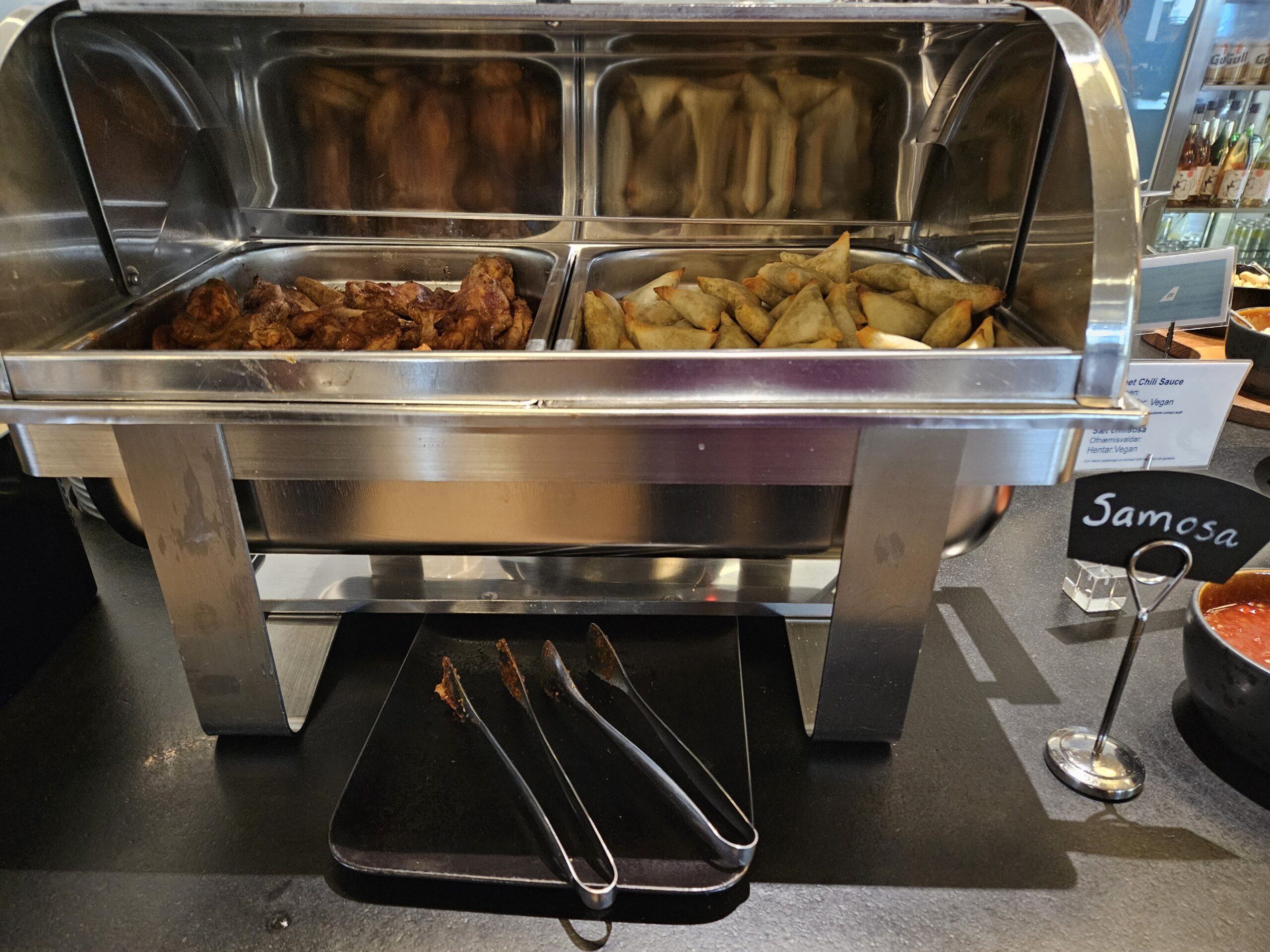 food in a buffet with tongs in Icelandair Saga Lounge