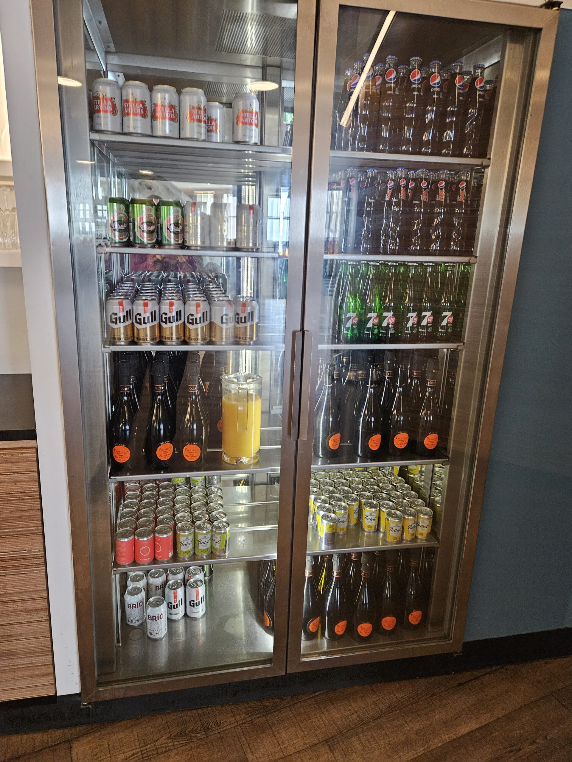 a large refrigerator with bottles of beer and cans Icelandair Saga Lounge